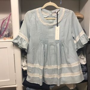 Blue and white ruffle detail shirt.